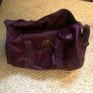 Small purple Reebok duffel bag (estimated 20-30L capacity), good for athletes